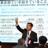Kosuke Motani, chief senior economist at the Japan Research Institute, Ltd., delivers a speech on Feb. 13 at a forum in Tokyo, organized by The Japan Times to commemorate the January launch of the Satoyama Consortium. | YOSHIAKI MIURA