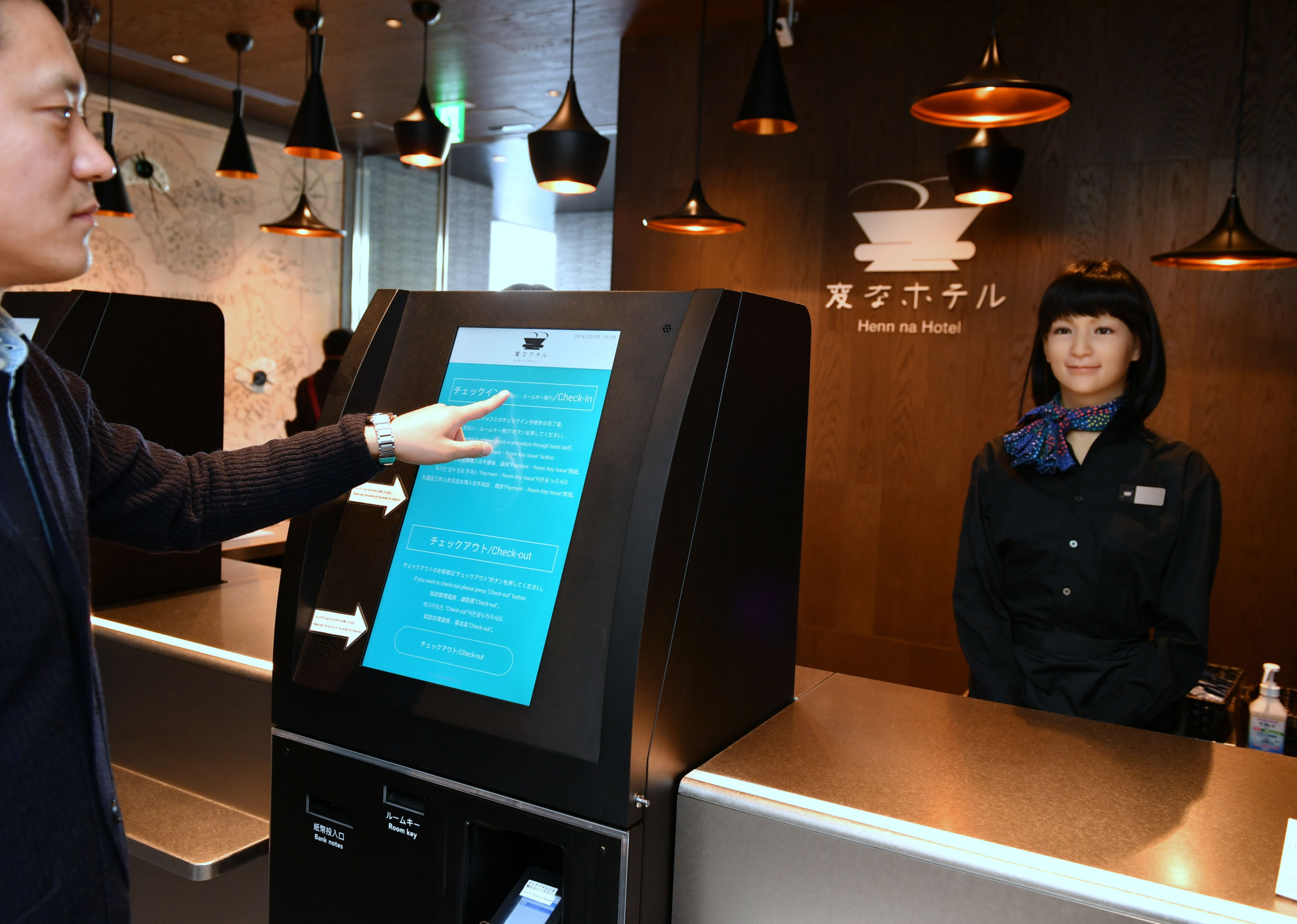 An android serves as a receptionist at the new Henn na Hotel that opened Thursday in Tokyo's Ginza district. | YOSHIAKI MIURA