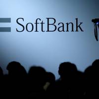 SoftBank Group Corp. logo displayed at a Tokyo conference. ﷯SoftBank Group Corp. will take a majority stake in Line Corp.\'﷯s mobile unit. | REUTERS