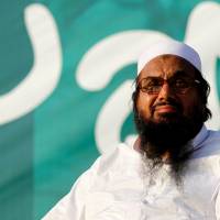 Hafiz Muhammad Saeed, chief of the banned Islamic charity Jamat-ud-Dawa, looks over the crowed as they end a \"Kashmir Caravan\" from Lahore with a protest in Islamabad in 2016. | REUTERS