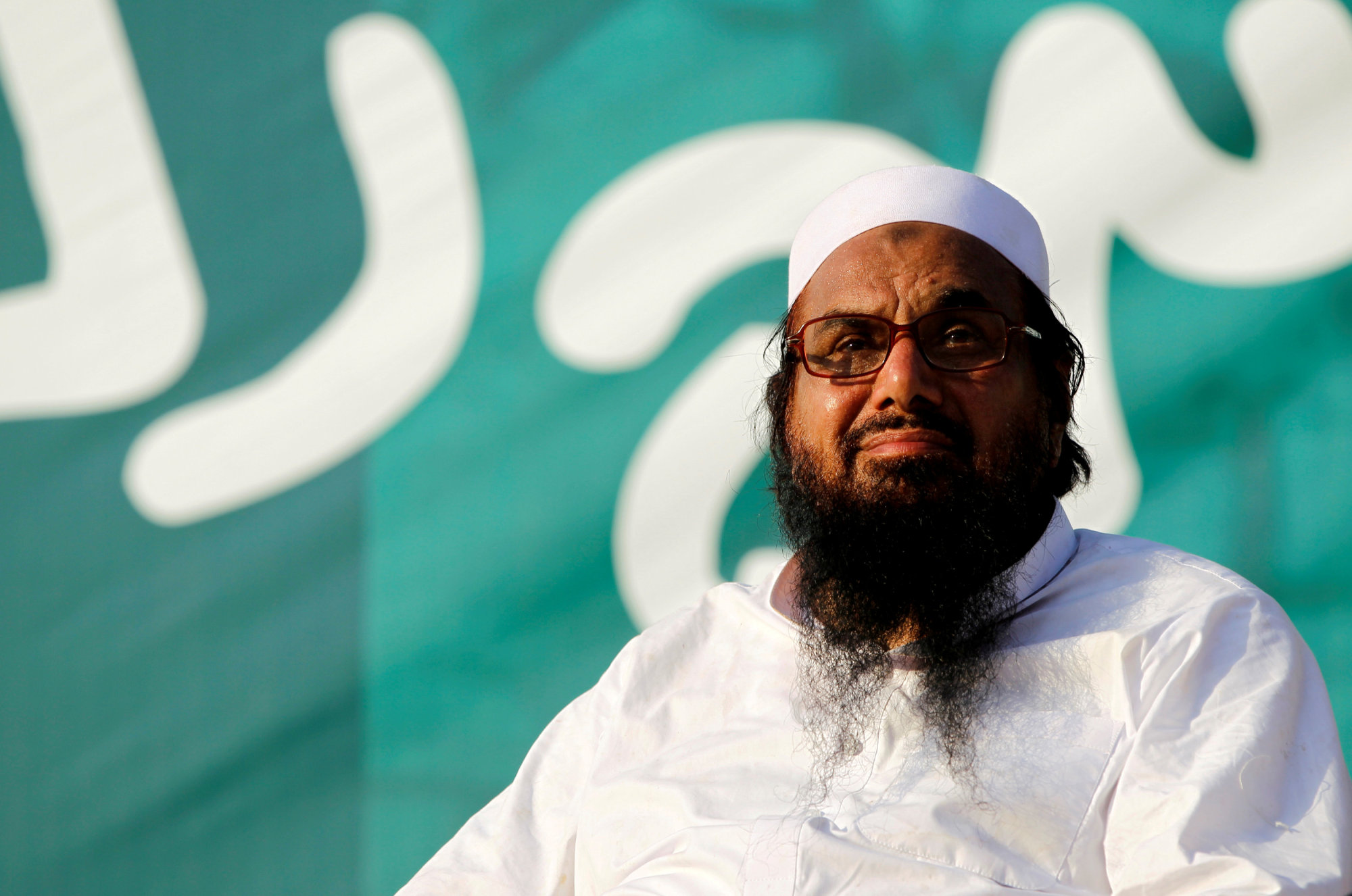 Hafiz Muhammad Saeed, chief of the banned Islamic charity Jamat-ud-Dawa, looks over the crowed as they end a 'Kashmir Caravan' from Lahore with a protest in Islamabad in 2016. | REUTERS