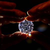 An assistant holds a 102.34-carat white diamond at Sotheby\'s auction house in London Thursday. | REUTERS