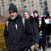 Immigration activist Ravi Ragbir walks during a demonstration against deportations at Federal Plaza in Manhattan, New York, Thursday. | REUTERS