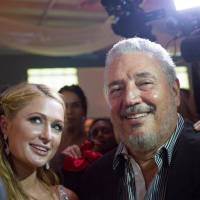 Fidel Castro Diaz-Balart, son of the late Cuban leader Fidel Castro, poses with Paris Hilton as she takes a selfie during the gala dinner of the closing of the XVII Habanos Festival, in Havana in 2015. | REUTERS