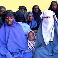 This photo made from a video released by the Islamist militant group Boko Haram on Jan. 15 shows at least 14 of the schoolgirls abducted from the northeast Nigerian town of Chibok in April 2014. | AFP-JIJI