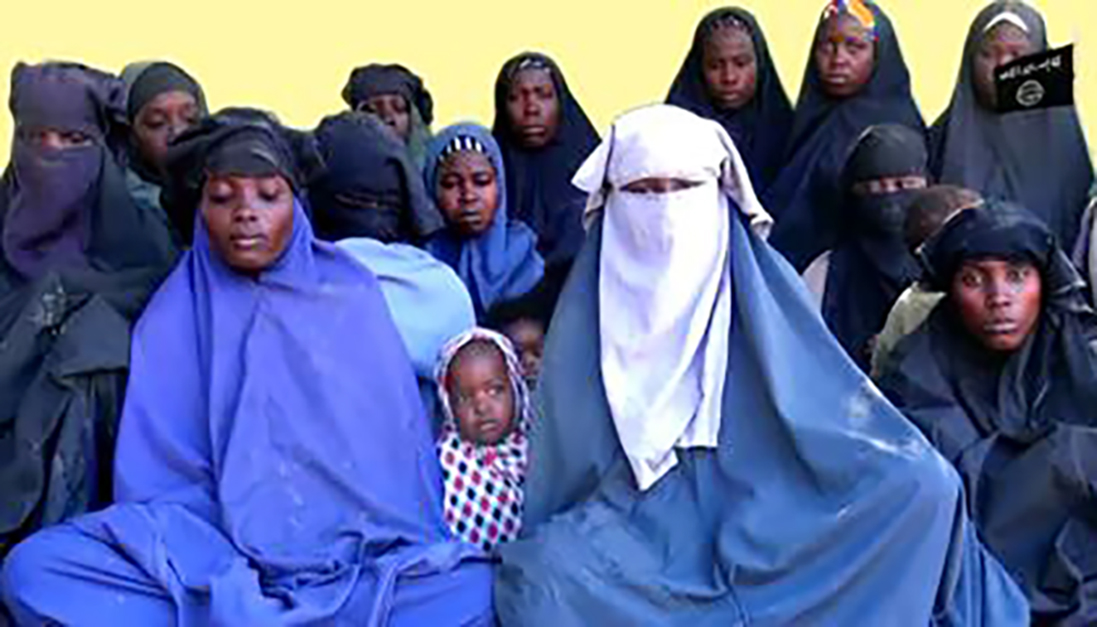 This photo made from a video released by the Islamist militant group Boko Haram on Jan. 15 shows at least 14 of the schoolgirls abducted from the northeast Nigerian town of Chibok in April 2014. | AFP-JIJI