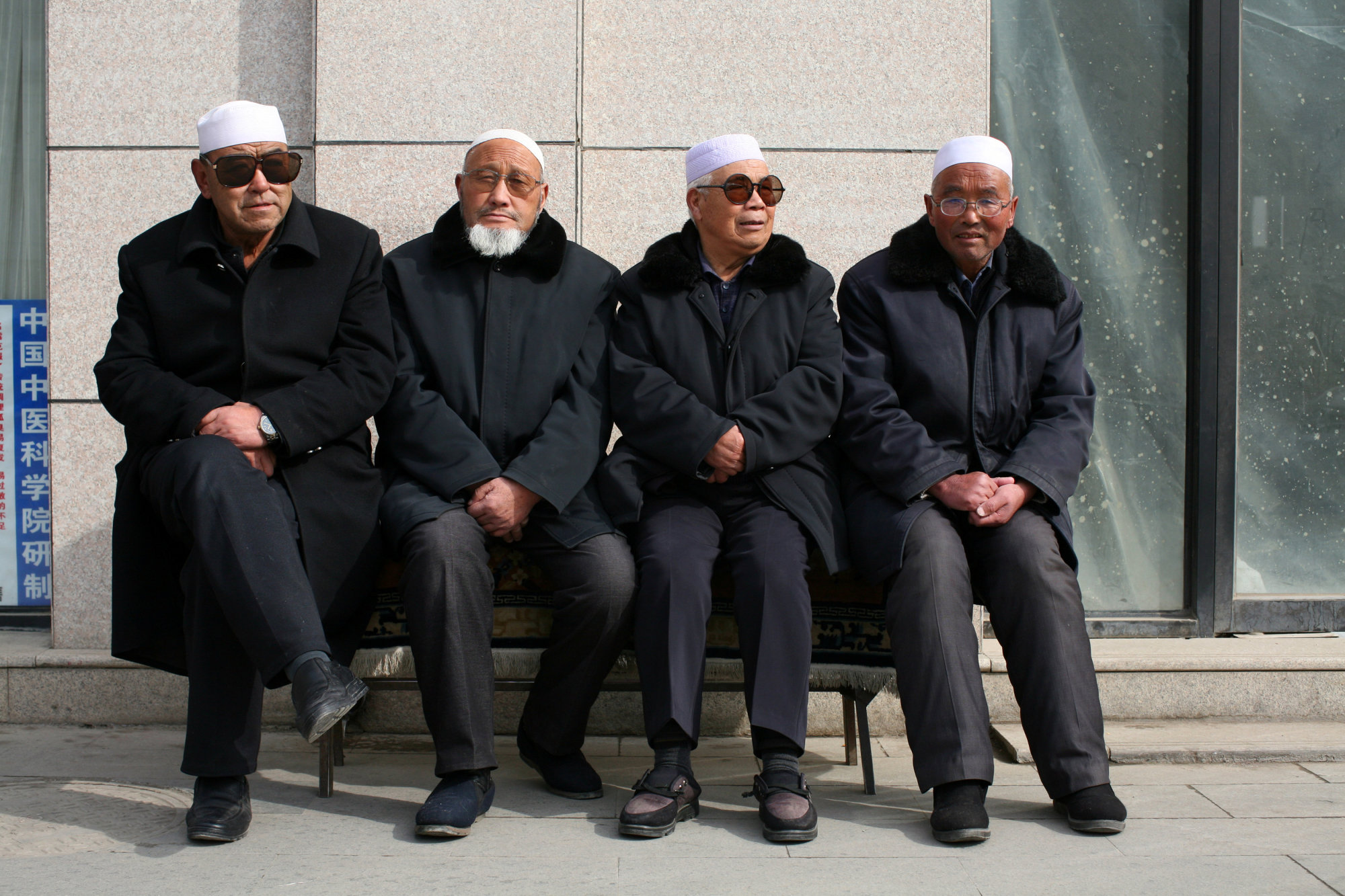 Men wait for afternoon prayers to begin at a mosque in Linxia, in China's Gansu province, home to a large population of ethnic minority Hui Muslims, on Feb. 1. | REUTERS
