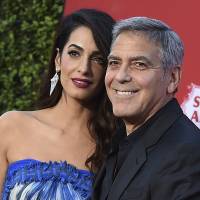 Amal Clooney and George Clooney arrive at the premiere of \"Suburbicon\" in Los Angeles in October. George and Amal Clooney are donating &#36;500,000 to students organizing nationwide marches against gun violence, and they say they\'ll also attend next month\'s planned protests. | JORDAN STRAUSS / INVISION / VIA AP