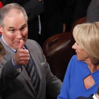U.S. Environmental Protection Agency (EPA) Administrator Scott Pruitt gives a thumbs up across the House chamber floor as he passes Education Secretary Betsy DeVos after U.S. President Donald Trump delivered his State of the Union address to a joint session of the U.S. Congress on Capitol Hill in Washington Tuesday. | REUTERS