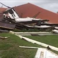 This image made from video shows parliament house damaged by Cyclone Gita in Nuku\'alofa, Tonga, Tuesday. Tonga began cleaning up Tuesday after the cyclone hit overnight, while some people in the nearby Pacific nation of Fiji began preparing for the storm to hit them. | TVNZ / VIA AP