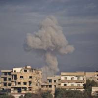 Smoke rises from buildings in Kafr Batna following Syrian government bombardments on the besieged eastern Ghouta region on the outskirts of the capital Damascus on Wednesday. | AFP-JIJI