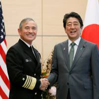 United States Pacific Command chief Adm. Harry Harris shakes hands with Prime Minister Shinzo Abe during a courtesy visit to Tokyo in November. | AFP-JIJI