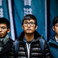 Hong Kong\'s leading democracy activists (from left to right) Joshua Wong, Nathan Law and Alex Chow arrive outside the Court of Final Appeal in Hong Kong on Tuesday. | AFP-JIJI