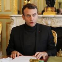 French President Emmanuel Macron speaks Friday during a Trianon Council meeting aiming to strengthen links between France and Russia at the Elysee Palace in Paris. | REUTERS