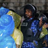 Maldives policemen clear the area around the supreme court after the government declared a 15-day state of emergency in Male early Tuesday. The Maldives government declared the state of emergency Monday as the political crisis deepened in the Indian Ocean nation amid an increasingly bitter standoff between the president and the Supreme Court. Hours after the emergency was declared, soldiers forced their way into the Supreme Court building, where the judges were believed to be taking shelter, said Ahmed Maloof, an opposition member of parliament. | AP