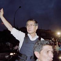 Then-Peruvian President Alberto Fujimori waves as he leaves the residence of the Japanese ambassador in Lima in April 1997. | AFP-JIJI