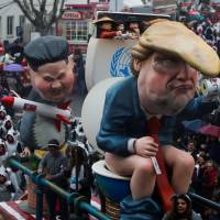 A carnival chariot is seen with figures of U.S. President Donald Trump and North Korean leader Kim Jong Un during a parade in Torres Vedras, Portugal, Sunday. | REUTERS