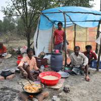 A man cooks a meal in his makeshift restaurant in the Vashan Char, previously known as Thengar Char island in the Bay of Bengal, Bangladesh, Feb. 14. | REUTERS