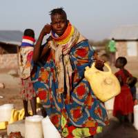 A Turkana woman washes her face at a water point within the Kalobeyei Settlement outside the Kakuma refugee camp in Turkana county, northwest of Nairobi, Thursday. | REUTERS