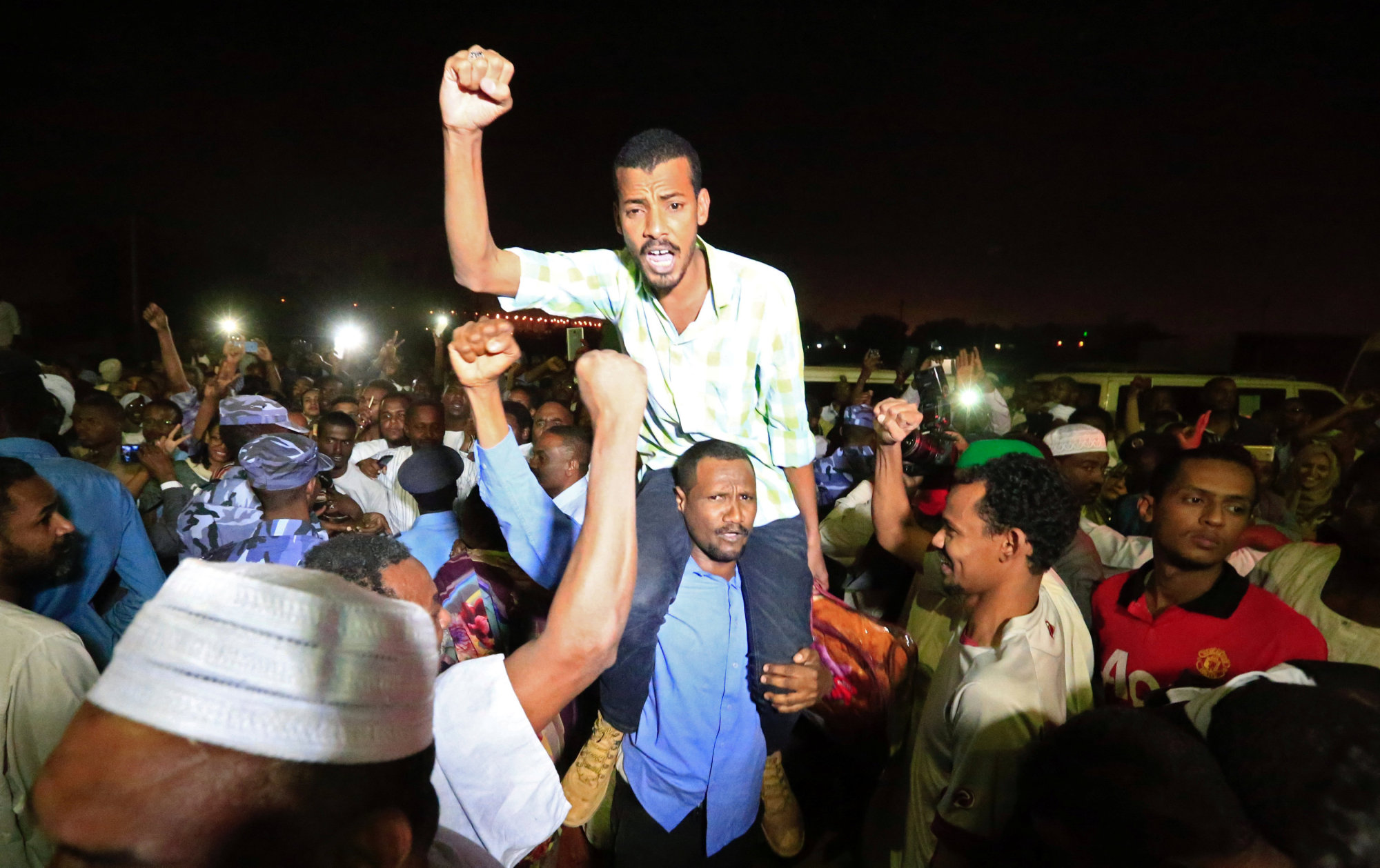 Supporters carry a released politician outside the National Prison, after demonstrations in Khartoum Sunday. | REUTERS