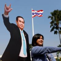 A child plays next to a cardboard cutout of Thai Prime Minister Prayuth Chan-ocha during a Children\'s Day celebration at Government House in Bangkok on Jan. 13. | REUTERS/JORGE SILVA