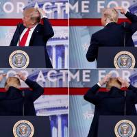 U.S. President Donald Trump pretends to smooth his hair as he speaks at the Conservative Political Action Conference in National Harbor, Maryland, on Friday. | REUTERS