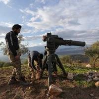 Turkish-backed Free Syrian Army fighters prepare a TOW anti-tank missile north of the city of Afrin, Syria, Sunday. | REUTERS