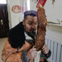 Craftsman Slanbek stretches horsehair as he makes traditional horsehide skis on the outskirts of Altay in the Xinjiang Uighur Autonomous Region of China on Jan. 25. | REUTERS