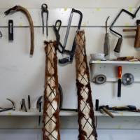 Horsehide skis made by Slanbek stand next to his tools. | REUTERS