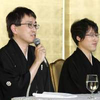 Shogi champion Yoshiharu Habu (left) and go master Yuta Iyama face reporters Tuesday after they were given the People\'s Honor Award. | KYODO