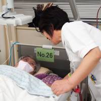 A nurse counselor talks with a patient about her wishes regarding end-of-life care at Kasugai Municipal Hospital in Aichi Prefecture in February 2016. | KYODO