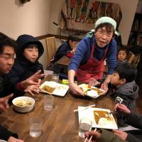 Hiroko Kondo serves meals to kids at her community space in Tokyo\'s Ota Ward on Feb. 1. | COURTESY OF DANDAN