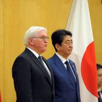 German President Frank-Walter Steinmeier (left) reviews the guard of honor with Prime Minister Shinzo Abe during a welcoming ceremony at the Prime Minister\'s Office in Tokyo on Tuesday. | REUTERS