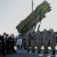 U.S. Vice President Mike Pence inspects PAC-3 missile interceptors with Defense Minister Itsunori Onodera at the Defense Ministry in Tokyo on Wednesday. | REUTERS