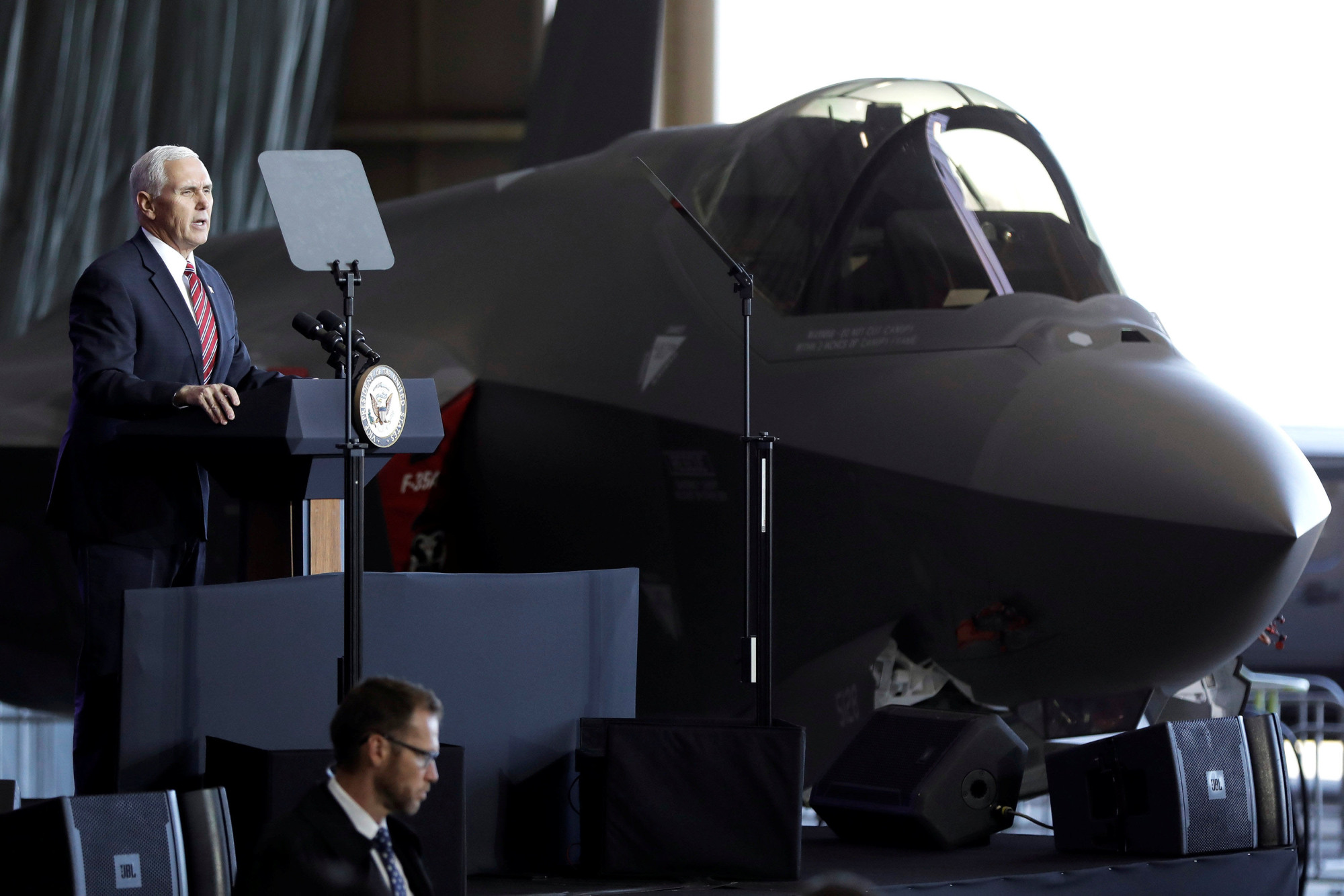 U.S. Vice President Mike Pence addresses members of the U.S. military and the Self-Defense Forces in front of a U.S. Air Force F-35 fighter at the Yokota Air Base on the outskirts of Tokyo on Thursday. | REUTERS