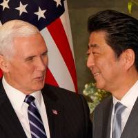 Prime Minister Shinzo Abe greets U.S. Vice President Mike Pence before their meeting at the Prime Minister\'s Office on Wednesday. | REUTERS