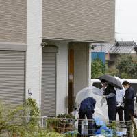 Police officers investigate a house in Kumagaya, Saitama Prefecture, in September 2015 after a woman and her 7- and 10-year-old daughters were found murdered. | KYODO