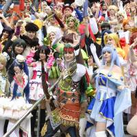 People dressed as their favorite anime and manga characters attend a cosplay event in Nagoya last August. | KYODO