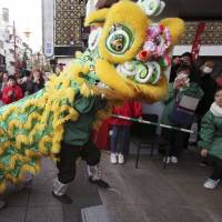Lion dancers celebrate the Chinese Lunar New Year in Yokohama on Friday. Over the Lunar New Year holidays in February, the Japan Tourism Agency said many travelers from China chose to visit snowy areas such as Hokkaido, the Tohoku region and Niigata Prefecture. | AP