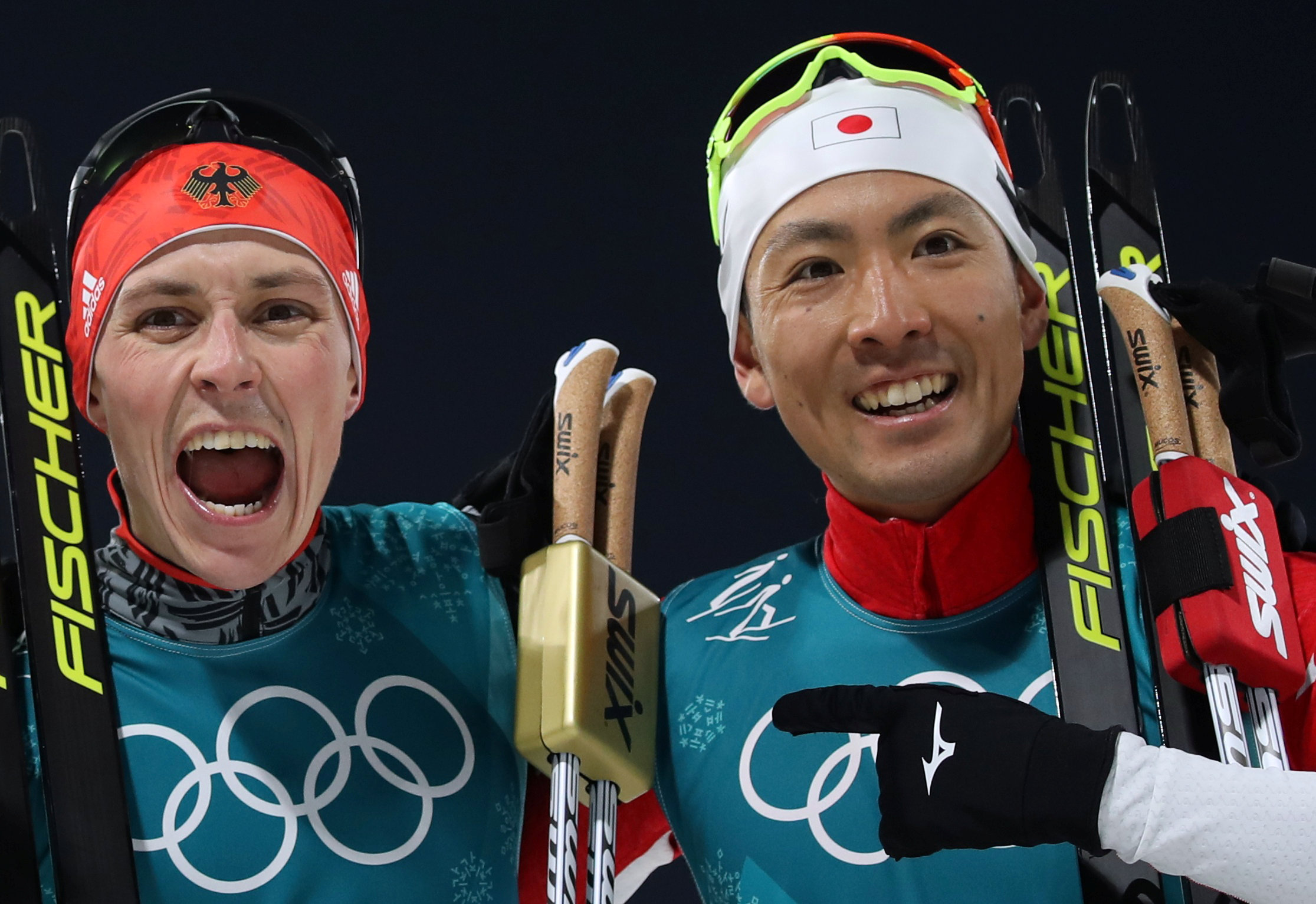 Eric Frenzel of Germany and Akito Watabe celebrate after crossing the finish line. | REUTERS