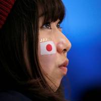 A fan watches the Switzerland vs Japan ice hockey match at Kwandong Hockey Centre. | REUTERS