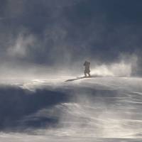 A crew member skis slowly down the slopes after the women\'s giant slalom was cancelled because of strong winds at the Jeongseon Alpine Center. | AFP-JIJI