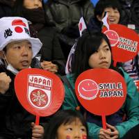 Fans of Japan\'s ice hockey team cheer at the Switzerland vs Japan game.  | REUTERS