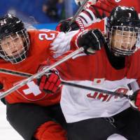 Isabel Waidacher of Switzerland and Mika Hori of Japan in action. | REUTERS