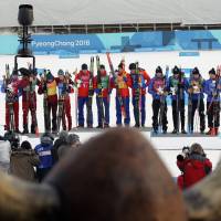 Following the men\'s 4x10 km cross-country relay, gold medallists Didirk Toenseth, Johnsrud Martin Sundby, Simen Hegstad Kreuger and Johannes Hoesflot Klaebo of Norway pose on the podium between silver medallists Andrey Larkov, Alexander Bolshunov, Alexey Chervotkin and Denis Spitsov, Olympic athletes from Russia, and bronze medallists Jean Marc Gaillard, Maurice Manificat, Clement Parisse and Adrien Backsheider of France | REUTERS