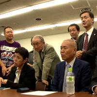Presenting their case: The plaintiffs line up in a scene from Kazuo Hara\'s \"Sennan Asbestos Disaster.\" The film tackles the fight for government compensation for deadly respiratory diseases caused by asbestos. | &#169; SHISSOH PRODUCTION