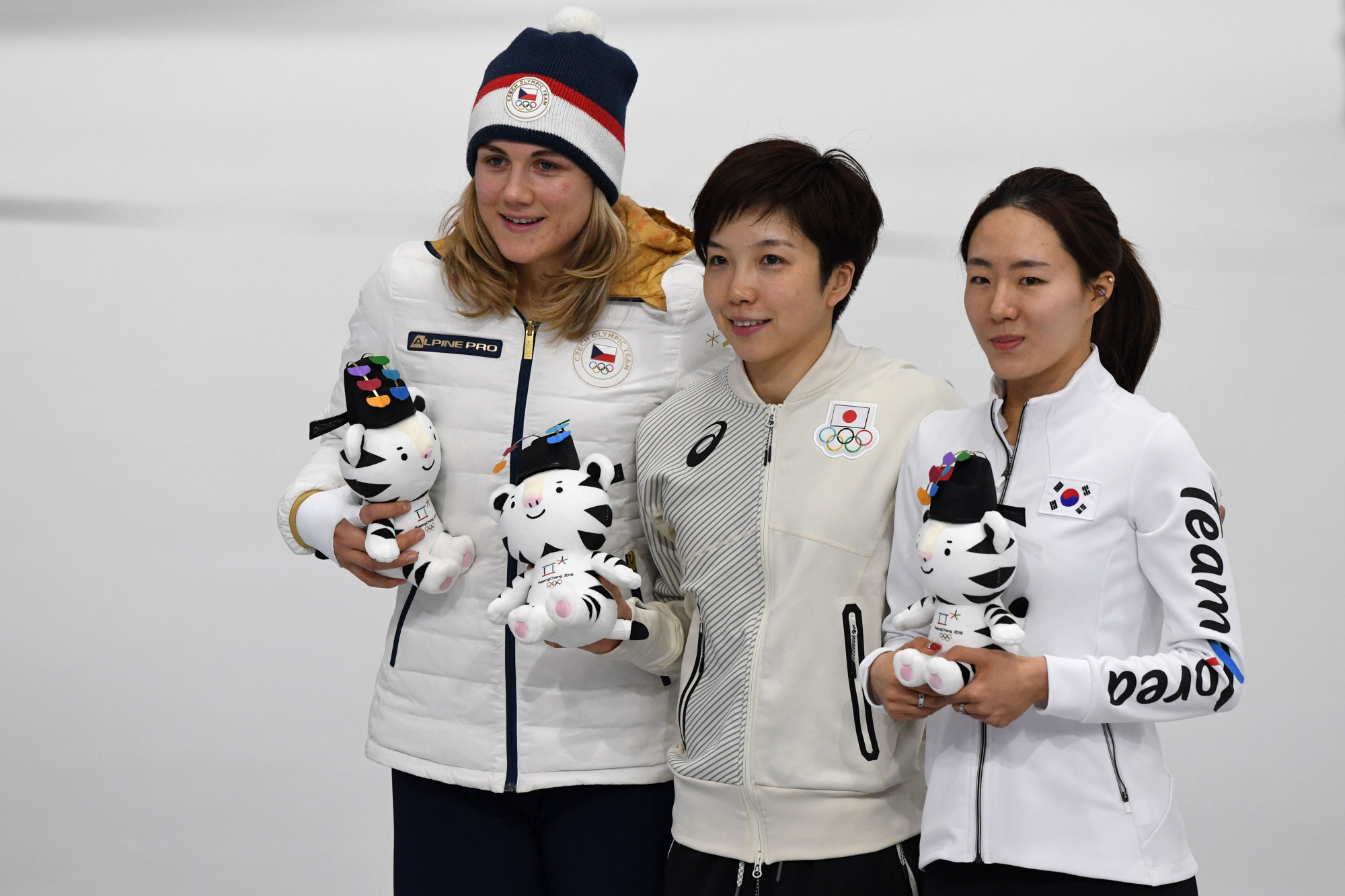 White knight: Gold medallist Nao Kodaira holds an Olympic mascot while posing for a photo with South Korea's Lee Sang-hwa and Czech Republic's Karolina Erbanova after the women's 500-meter speed skating competition on Feb. 18. | AFP-JIJI