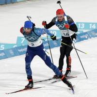 France\'s Martin Fourcade (left) and Germany\'s Simon Schempp race during the men\'s 15-km mass start biathlon on Sunday in Pyeongchang, South Korea. | AP
