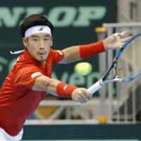 Yuichi Sugita hits a return to Italy\'s Andreas Seppi in their Davis Cup World Group first-round tie on Friday in Morioka, Iwate Prefecture. Sugita held off Seppi, winning 4-6, 6-2, 6-4, 4-6, 7-6 (7-1). | KYODO