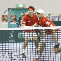 Japan\'s Ben McLachlan (right) and Yasutaka Uchiyama face Italy\'s Simone Bolelli and Fabio Fognini in a  Davis Cup World Group first-round tie on Saturday in Morioka, Iwate Prefecture. The Italians won 7-5, 6-7 (4-7), 7-6 (7-3), 7-5. | KYODO